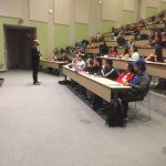 Paul Jones presenting in front of students in a lecture hall