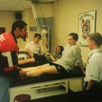 A photo of kinesiology students in a room practicing