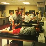 A group of kinesiology students in a room practicing