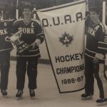 An old photo of hockey players holding OUAA Hockey Champions 1986-87