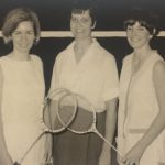 An old photo of two female badminton players and their coach