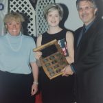 A female athlete with their perpetual plaque
