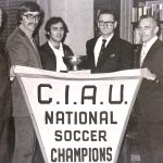 An old photo of people holding a CIAU National Soccer Champions banner