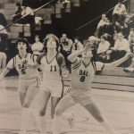 An old photo of female basketball players looking up for the ball