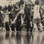 An old photo of female basketball players going for the ball