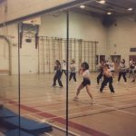 An old photo of students doing aerobics reflected in the mirrors