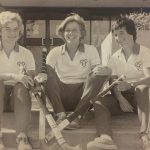 An old photo of three female field hockey players