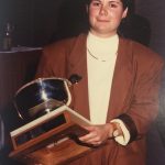 A man holding a trophy