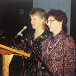 A photo of two women behind a lectern