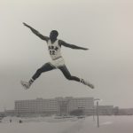 An old photo of an athlete making a jump in track and field