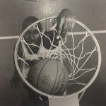 An overhead shot of a basketball player scoring a ball