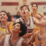 A photo of female basketball athletes looking up for the ball