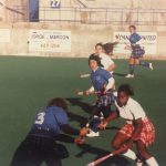 Female field hockey players playing in a field