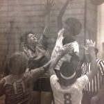 An old photo of female basketball players jumping for the ball