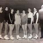 An old team photo of figure skaters on ice rink