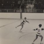 An old photo of figure skaters skating on an ice rink