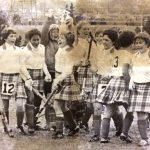 An old photo of female field hockey players celebrating