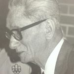 An old photo of an elder wearing glasses