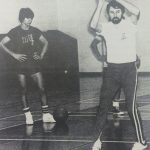 An old photo of a basketball coach and athletes in a practice session