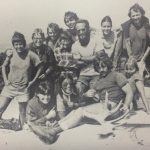 An old group photo of people on a mountain
