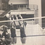 An old photo of female volleyball players blocking a shot