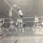 An old photo of female volleyball players jumping for a ball