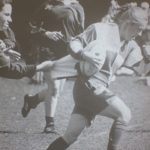 An old photo of female athletes playing rugby