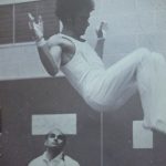 An old photo of a male gymnast practicing
