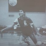 A volleyball athlete diving at an incoming ball