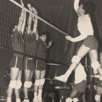 Photo of volleyball players going at the ball