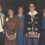 Carol Wilson with athletes holding trophies