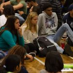 A close shot of students sitting in circles