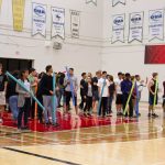 Students gathering to participate in a noodle throwing activity