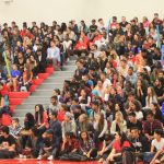 Students in the indoor gym seating