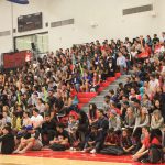 Students in the indoor gym seating