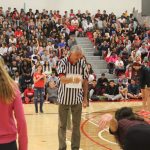 The head referee amidst the students