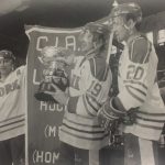 At Mens Hockey 84-85 CIAU Champs with a man holding a trophy