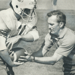 referee handing an athlete a football