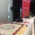 A lateral shot of a 50th anniversary cake on a table