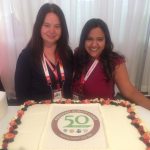 A photo of two girls with the 50th anniversary cake